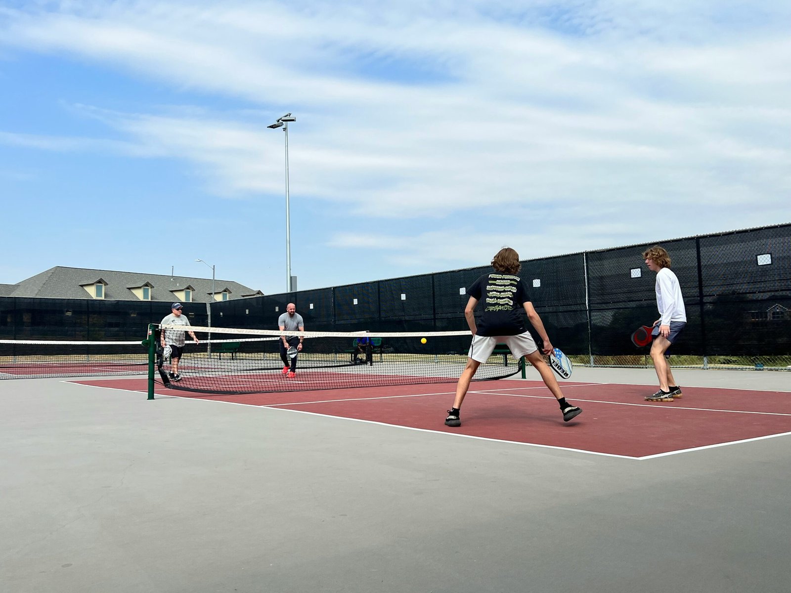 a group of people play tennis